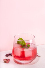 Hibiscus Water or lemonade, summer infused flower drink with iced hibiscus tea, lime slices and...
