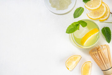 Iced Matcha Lemonade cocktail. Green iced matcha tea infused drink with lemon slices and fresh mint...