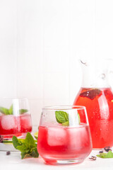 Hibiscus Water or lemonade, summer infused flower drink with iced hibiscus tea, lime slices and mint, refreshing and cooling, healthy hydration pink natural cocktail