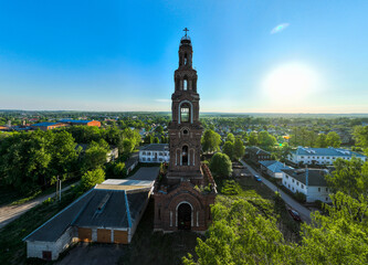 An aerial shot captures a tall, historic bell tower in Yuryev Polsky, Russia, silhouetted against a...