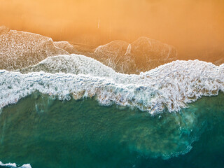 Aerial View of Ocean Waves Hitting Sandy Shore. Aerial drone view. natural background