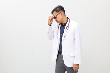Very upset, charming doctor man touching nose between closed eyes, wants to cry, having stressful...