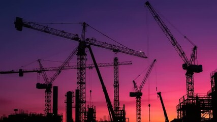 Construction site silhouettes at sunset with cranes - Powered by Adobe