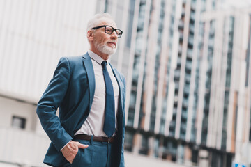 Confident senior businessman in formal suit showcasing leadership and professionalism in an urban...