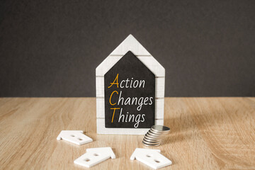 Concept words Action, Changes and Things on black blackboard. Beautiful wooden table, black...