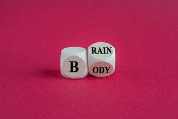 Body vs Brain symbol. Turned a dice and changes word Brain to Body. Beautiful red background. Business and Body vs Brain concept.