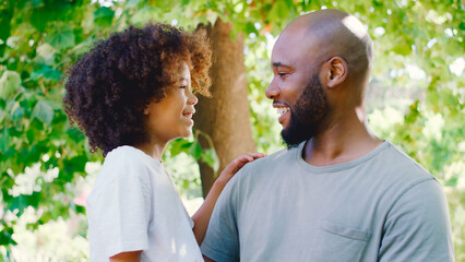 Portrait Of Loving Father And Son In Summer Garden Together