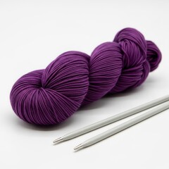 purple yarn with a pair of knitting needles on a solid white background, knitting and crafting resource image