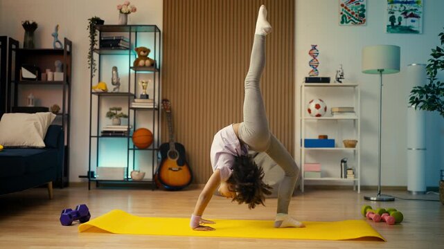 Athletic African American girl doing a backbend, practicing acrobatic exercises