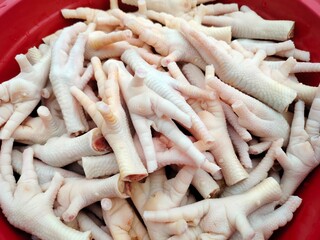 Freshly cleaned chicken feet stacked together, ready to be cooked into a variety of savory dishes....