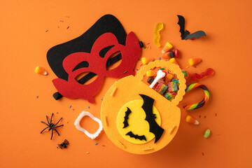 Vibrant Halloween setup featuring a colorful mask, candies, and themed decorations on orange