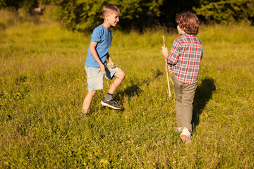 Cute little boys playing in nature on sunny day