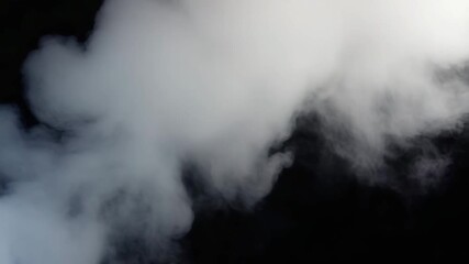 Endless Moving Steam or Smoke Loop. White smoke billowing against a dark backdrop, creating a mysterious and captivating atmosphere perfect for atmospheric effects and abstract visuals.