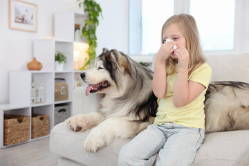 Girl suffering from allergy with her dog at home