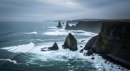 Fototapeta premium Dramatic moody seascape of rugged volcanic cliffs and sea stacks along a stormy northern coastline.