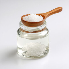 coconut oil glass jar bottle with spoon, white background.