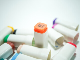 Vibrant collection of colorful art markers with orange cap labeled 23 Orange, ready for creative projects