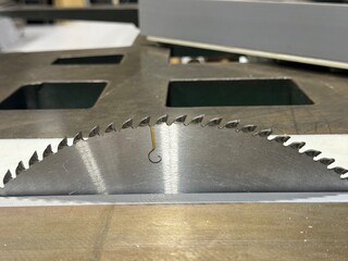 Close up of circular saw cutting pvc board in workshop