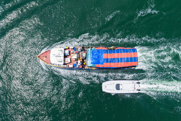 Shipping logistics. Commercial shipping. Top view. Cargo ship in sea, aerial view. Freight...