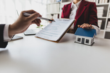 Real estate agents negotiate for businessman to legally sign home purchase agreements contract ,...