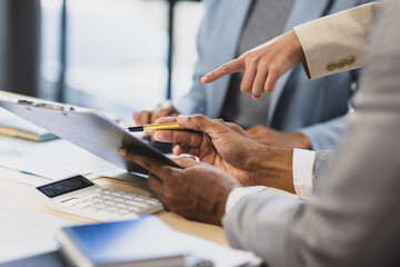 Meeting of businessmen and financial advisors analyzing financial report documents on work desk. Statistical analysis, finance and business planning.