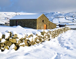 Snowy stone barn in a wintry landscape