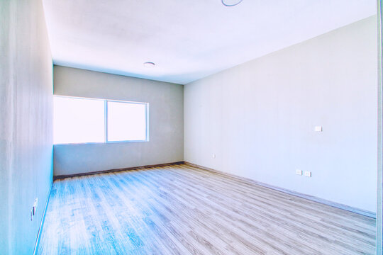 Clean unfurnished apartment interior showcasing spacious layout, raw architectural details, and abundant natural light. 