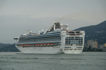 Modern Princess cruiseship cruise ship liner Grand set sail away from Vancouver, Canada port on cloudy day with light rain before Alaska cruise British Columbia