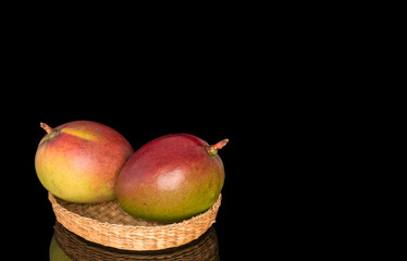 Ripe juicy mangoes on a black background, close-up.