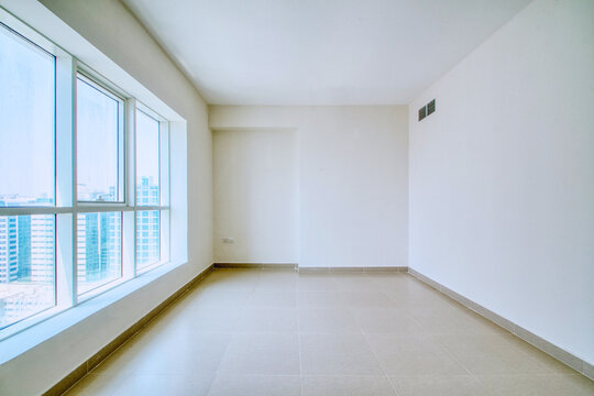 Clean unfurnished apartment interior showcasing spacious layout, raw architectural details, and abundant natural light. 