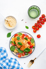 Salad with chicken fillet, couscous, cherry tomatoes, red onion, fresh spinach and orange slices,...