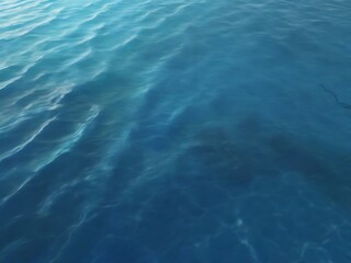 Obraz premium Close up of calm blue ocean water with gentle ripples and light reflections
