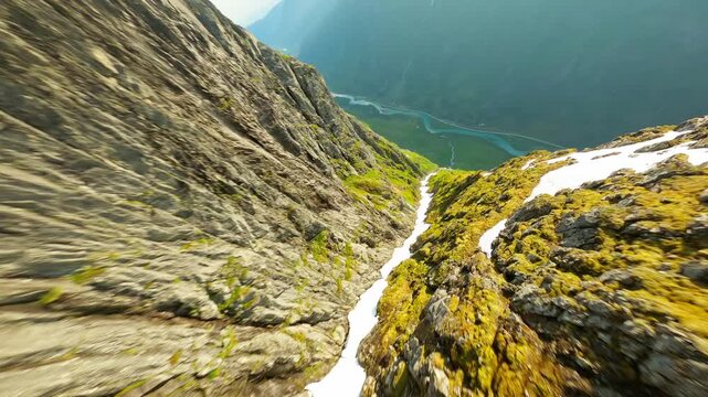 Aerial view of Geirangerfjord, where majestic mountains meet emerald waters, creating a breathtaking natural canvas of vibrant greens and blues, Stranda Municipality, Norway.