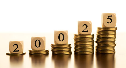 Gold Coins Stacked with 2025 Wooden Blocks on Table Showing Financial Growth and Future Investment on Warm Background