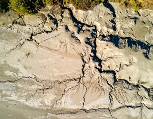 Cracked dry earth with intricate patterns from above, natural textures
