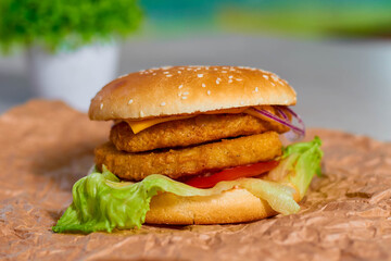 Delicious Hamburger with Onion and Lettuce on Wooden Table