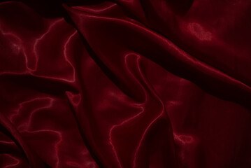 The luxurious red satin fabric surface is wavy and beautiful, conveying a deep love and relationship.