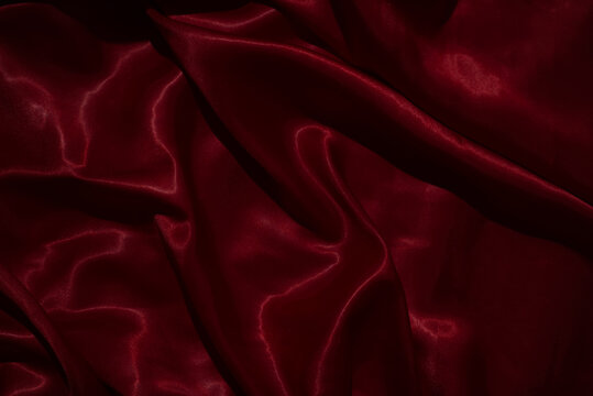 The luxurious red satin fabric surface is wavy and beautiful, conveying a deep love and relationship.