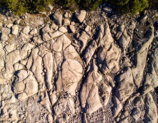 Textured natural rock formations reveal intricate geological patterns under sunlight