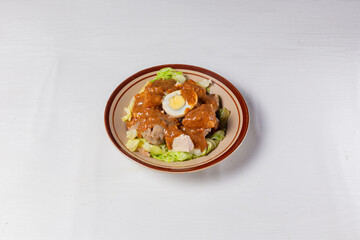 Healthy Fresh Indonesian Siomay - Mixed Vegetables & Fish Dimsum with Rich Peanut Dressing & Boiled Egg. Isolated in White Background
