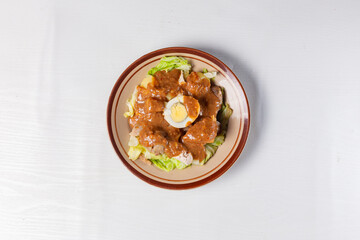 Healthy Fresh Indonesian Siomay - Mixed Vegetables & Fish Dimsum with Rich Peanut Dressing & Boiled Egg. Isolated in White Background