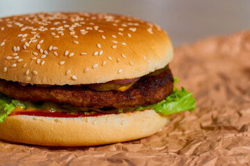 Delicious Hamburger with Onion and Lettuce on Wooden Table