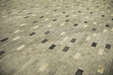 Patterned Cobblestone Pavement with Mixed Light and Dark Gray Tiles Creating a Geometric Design