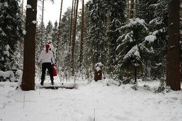 Woman in Red Hat and White Jacket Enjoying Winter Forest Snowfall Scenery