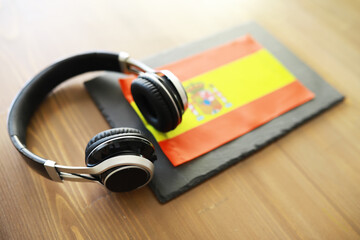 Headphones Resting on Spanish Flag - Music and Culture Symbol