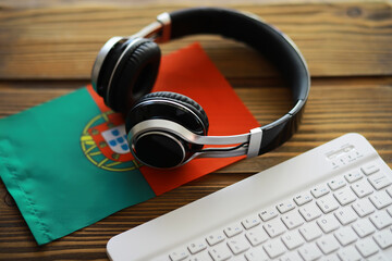 Headphones on Portugal Flag with Keyboard: Work, Music, and Culture Concept