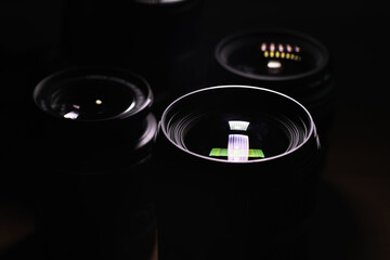 Professional Camera Lenses Close-Up with Reflections and Highlights in Low Light