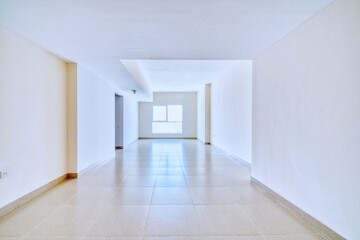 Clean unfurnished apartment interior showcasing spacious layout, raw architectural details, and...