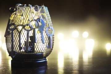 Vintage Keys Hanging on Wire Mesh Cage with Bokeh Lights in Background