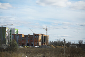 Urban Construction Site with High-Rise Buildings and Cranes Under Blue Sky